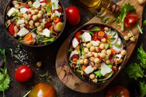 Chickpea salad with vegetables and microgreens top view