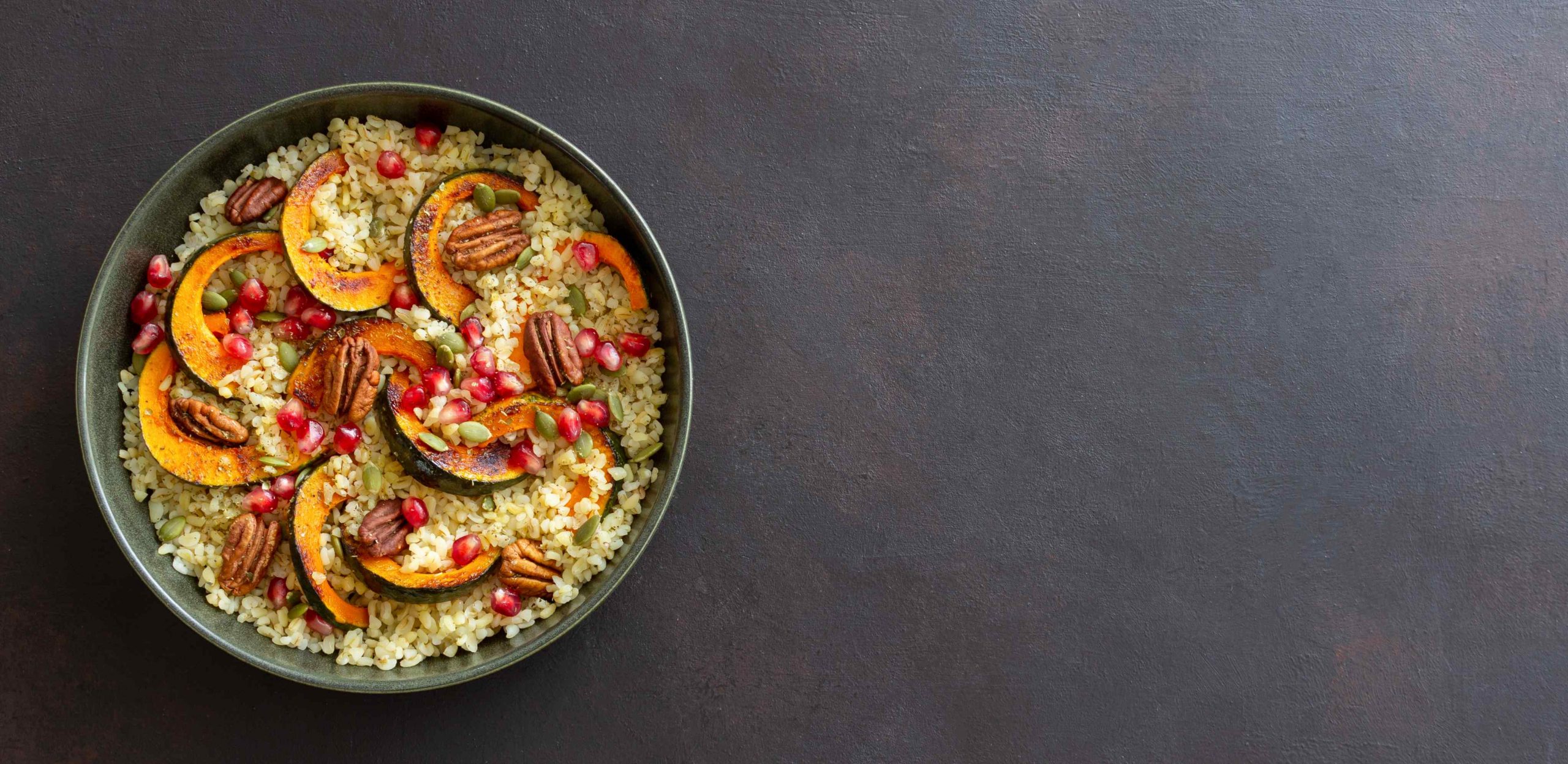 Bulgur with pumpkin, pomegranate and pecan nut. Healthy eating. Vegetarian food